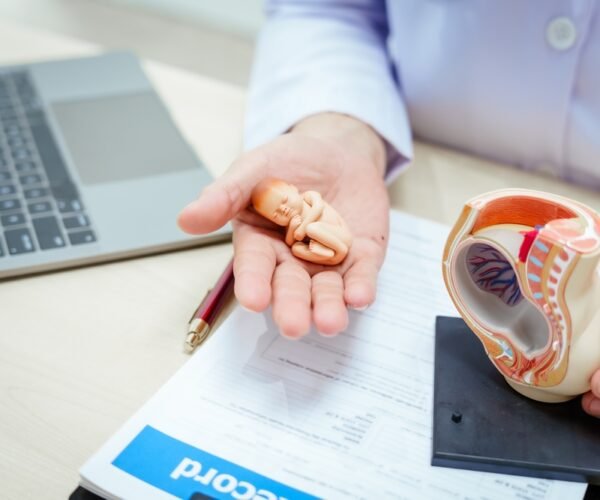 A,Male,Doctor,In,A,Hospital,Sits,At,A,Desk,