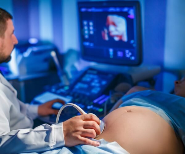 doctor-makes-ultrasound-scan-pregnant-woman-looks-screendrives-apparatus-2048x1365